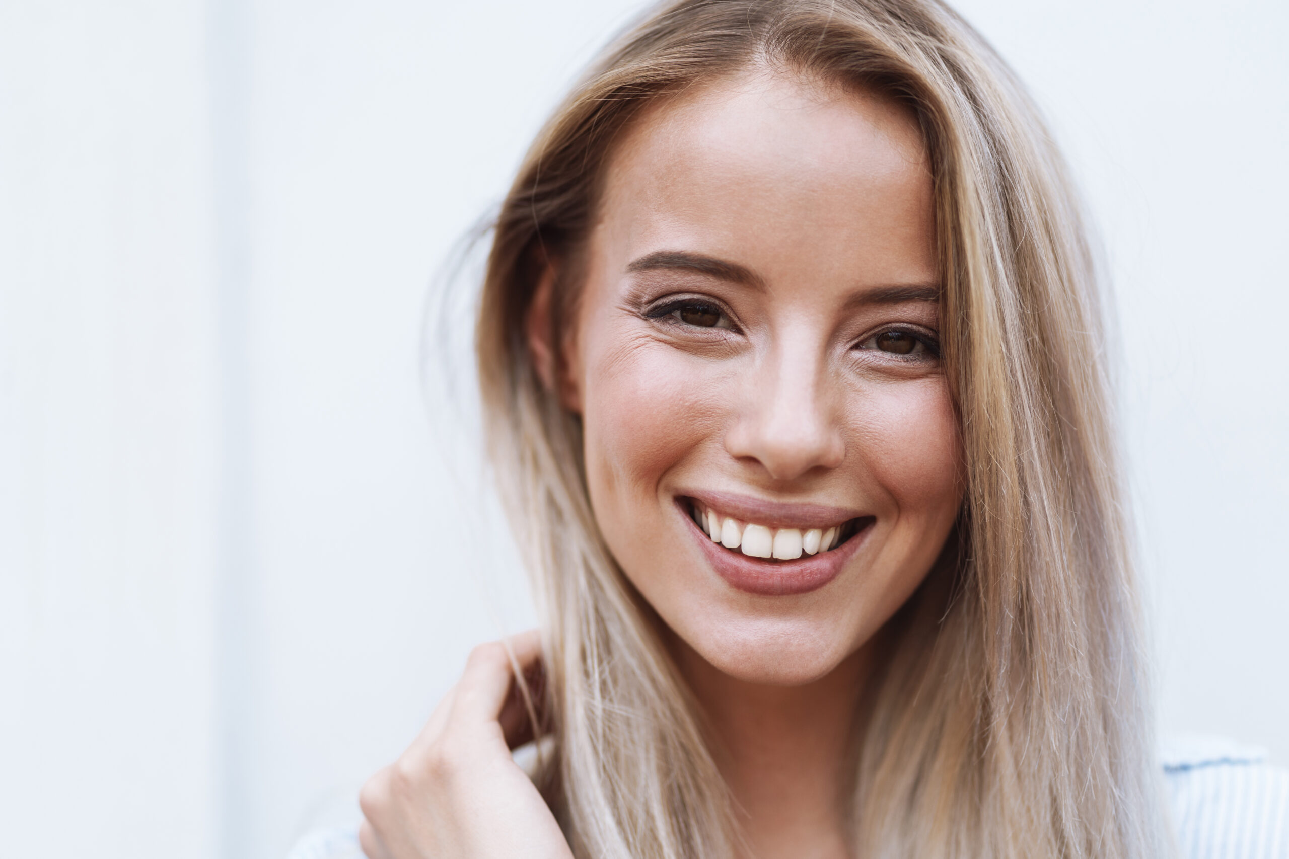Close-up of patient smiling showing cosmetic dental results comparing bonding and porcelain veneers